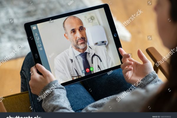 stock-photo-back-view-of-woman-making-video-call-with-her-doctor-while-staying-at-home-close-up-of-patient-in-1683359032